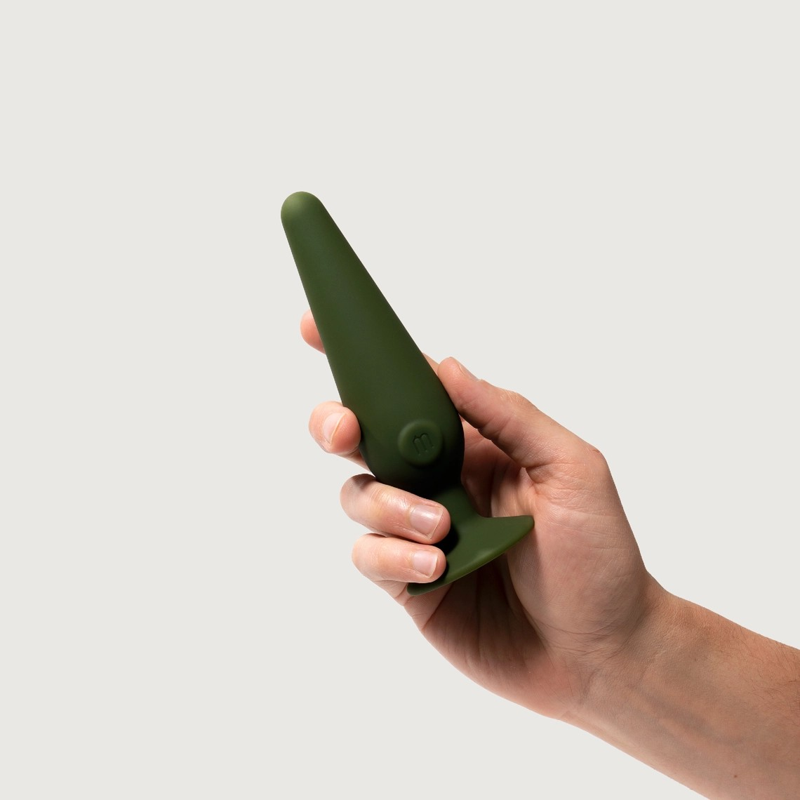 Image of a hand holding the Maude medium cone vibrating plug.